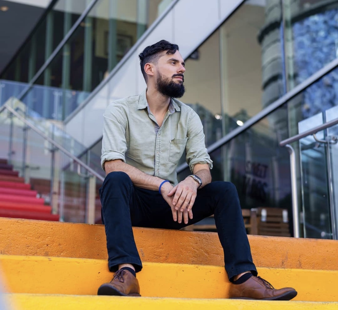 JFB Productions photographer seated on bright outdoor steps